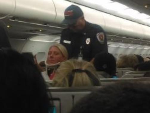 A flight attendant is fitted with a neck brace after the horror Jetblue flight.