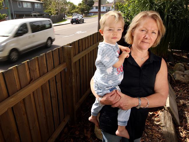 Sue Alder with grandson Zac at her home in Frenchs Forest. The family’s fence has been flattened 15 times in the past 20 years by out-of-control motorists. Picture: Sam Ruttyn