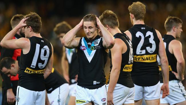 Port Adelaide players can’t believe it after the preliminary final loss.