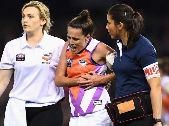 MELBOURNE, AUSTRALIA - SEPTEMBER 02:  Emma Zielke of the Allies is helped from the ground by trainers during the AFL Women's State of Origin match between Victoria and the Allies at Etihad Stadium on September 2, 2017 in Melbourne, Australia.  (Photo by Quinn Rooney/Getty Images)