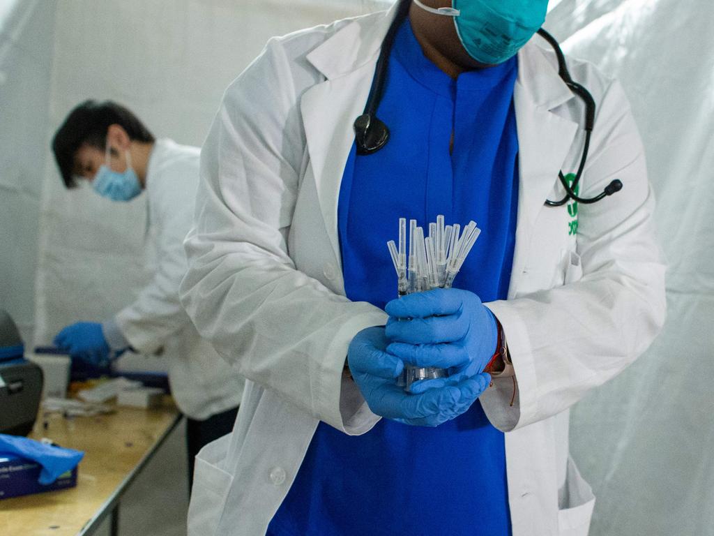 A health worker carries syringes to administer Pfizer Covid-19 vaccines at Corsi Houses in Harlem, New York. Picture: AFP