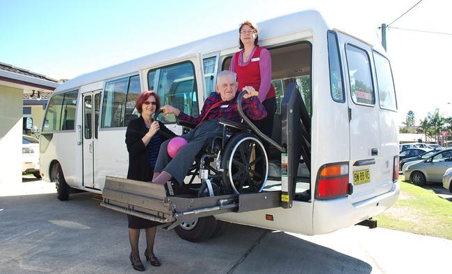 Harry Potts rides the lift on Byron Aged Care's new bus accompanied by activities officer Lyn McBurney (right) and CEO Margaret Geoghegan. Picture: Christian Morrow