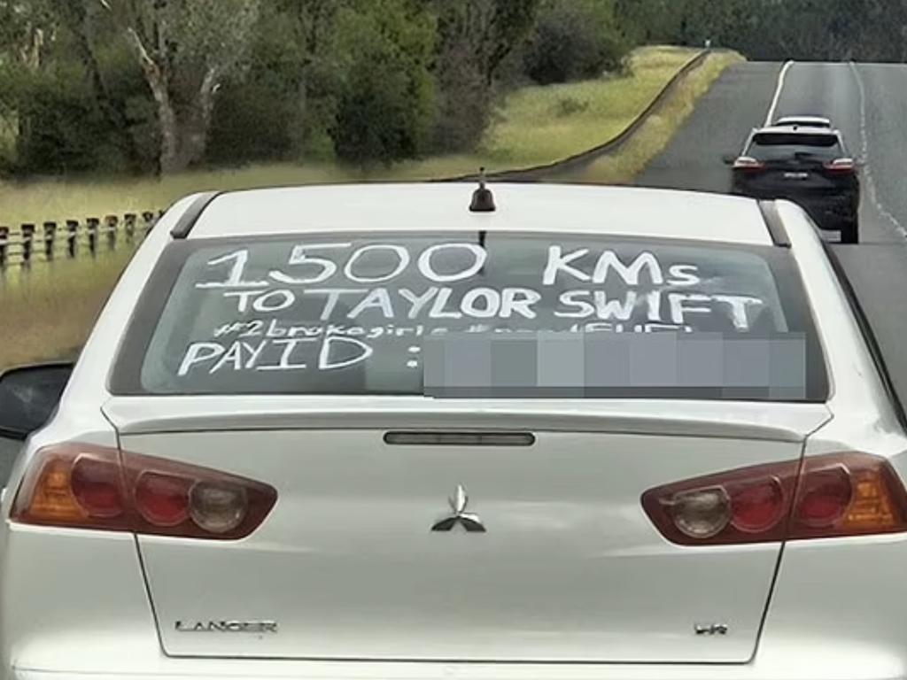 A sign they scribbled on the back window of their car has attracted some negative attention.