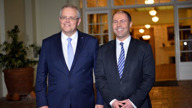 New Australian Prime Minister Scott Morrison (L) and deputy Liberal party leader Josh Frydenberg (R) pose for photos following the oath-taking ceremony of the prime minister's office in Canberra on August 24, 2018. - Scott Morrison was sworn in as Australia's seventh prime minister in 11 years on August 24 after a stunning party revolt against Malcolm Turnbull, which the new leader admitted had left the government "bruised and battered". (Photo by SAEED KHAN / AFP)