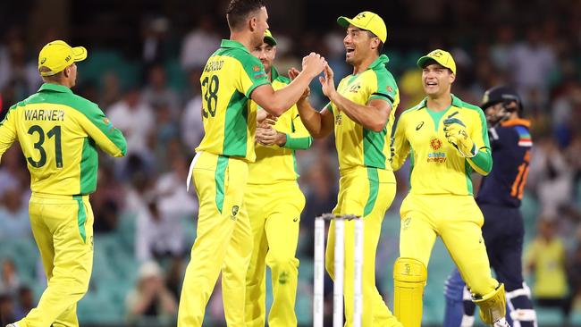 Josh Hazlewood of Australia celebrates with his team after taking the wicket of Virat Kohli of India during game one of the One Day International series between Australia and India at Sydney Cricket Ground on November 27, 2020 in Sydney, Australia. (Photo by Mark Kolbe/Getty Images)