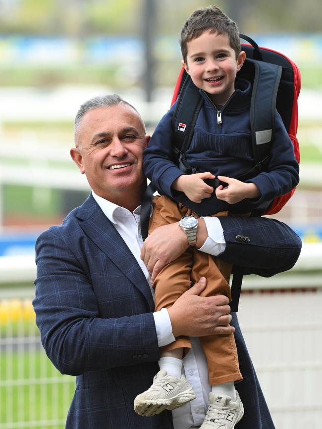 John Kanga with his godson, Oakley McNeil, the son of jockey Jye McNeil. Picture: Vince Caligiuri / Getty Images