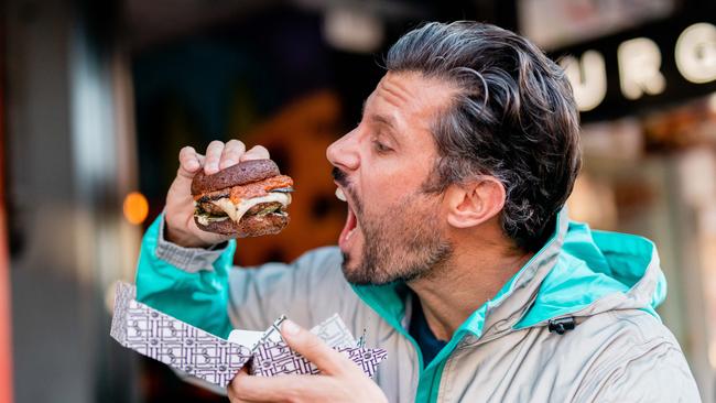 Sam Wood tucking into a BL Dad Bod Burger.