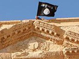 TO GO WITH AFP STORY BY RITA DAOU (FILES) An image made available by Jihadist media outlet Welayat Homs on May 28, 2015 allegedly shows a flag of the Islamic State (IS) group fluttering atop the circular wall bounding the orchestra at the Roman theatre of the ancient city of Palmyra, a 2,000-year-old metropolis and an Unesco world heritage site located 215 kilometres northeast of Damascus. In the year since it proclaimed its "caliphate," the Islamic State group has become the world's most infamous jihadist organisation, attracting international franchises and spreading fear with acts of extreme violence. The group proclaimed its self-described caliphate on June 29, 2014, urging Muslims worldwide to pledge allegiance to its leader Abu Bakr al-Baghdadi, renamed Caliph Ibrahim. The group pledged to make "the West and the East... submit," and has seized territory in northern and western Iraq and eastern and northern Syria.. AFP PHOTO / HO / WELAYAT HOMS === RESTRICTED TO EDITORIAL USE - MANDATORY CREDIT "AFP PHOTO / HO / WELAYAT HOMS" - NO MARKETING NO ADVERTISING CAMPAIGNS - DISTRIBUTED AS A SERVICE TO CLIENTS FROM ALTERNATIVE SOURCES, AFP IS NOT RESPONSIBLE FOR ANY DIGITAL ALTERATIONS TO THE PICTURE'S EDITORIAL CONTENT, DATE AND LOCATION WHICH CANNOT BE INDEPENDENTLY VERIFIED ===