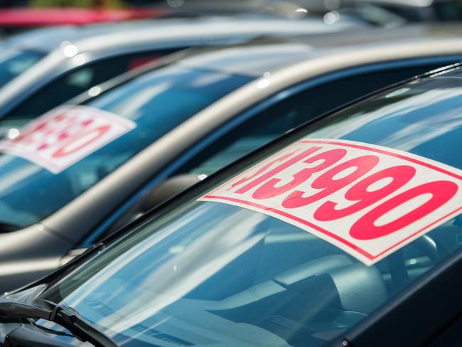 Generic image of vehicle with splash price tag in used car yard.