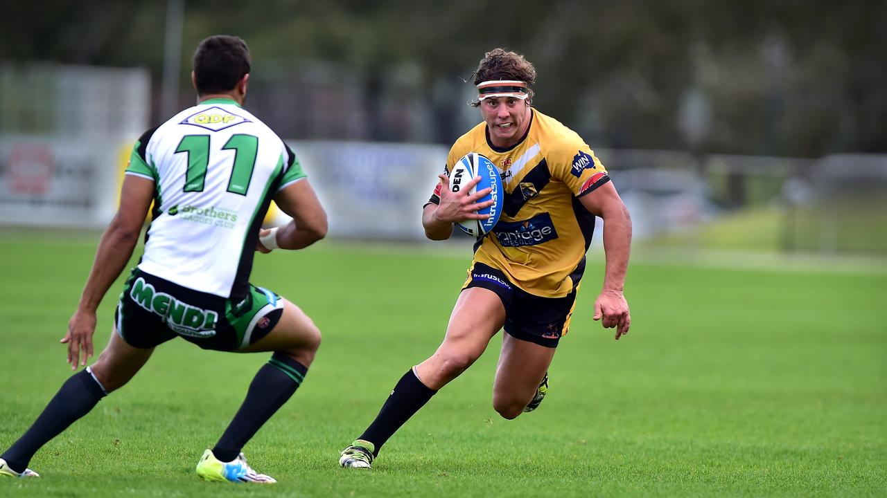 Falcons captain, Tom Murphy, runs at the Townsville defence during his playing days. Picture: Che Chapman.