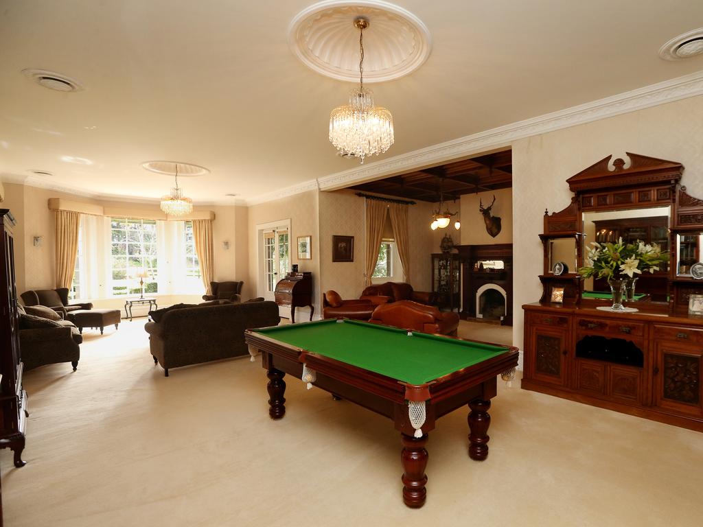 The grand foyer provides an impressive introduction to formal and informal living and dining spaces, while bohemia red glass feature windows, hand-etched and signed by the master craftsman, frame the front door. Picture: Andy Rogers