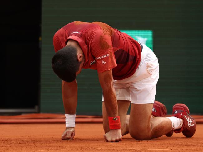 PARIS, FRANCE - JUNE 03: Novak Djokovic of Serbia after falling on the court stretching for a shot against Francisco Cerundolo of Argentina in the Men's Singles fourth round match during Day Nine of the 2024 French Open at Roland Garros on June 03, 2024 in Paris, France. (Photo by Clive Brunskill/Getty Images)