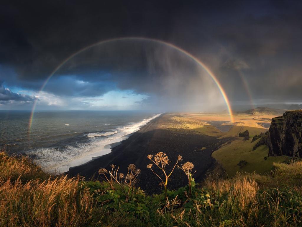 Rainbow formations seen on the coastline of Dyrholaey, Iceland. Picture: Mikhail Shcheglov/Royal Meteorological Society/Media Drum/Australscope