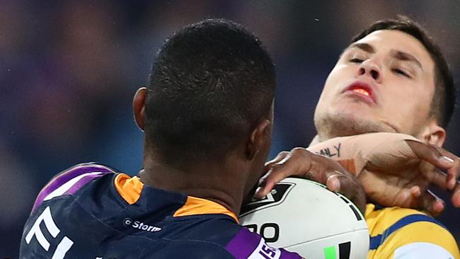 MELBOURNE, AUSTRALIA - SEPTEMBER 21: Mitchell Moses of the Eels is tackled by Suliasi Vunivalu of the Storm during the NRL Semi Final match between the Melbourne Storm and the Parramatta Eels at AAMI Park on September 21, 2019 in Melbourne, Australia. (Photo by Kelly Defina/Getty Images)