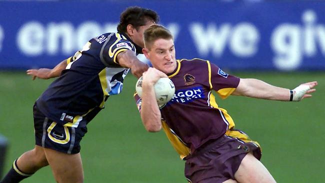 A baby-faced Brent Tate bursts through the Cowboys defence in 2002.