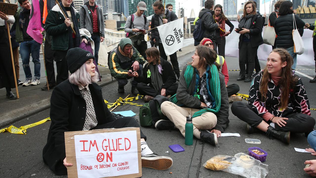 Activists glued themselves to the King St Bridge. Picture: AAP Image/David Crosling