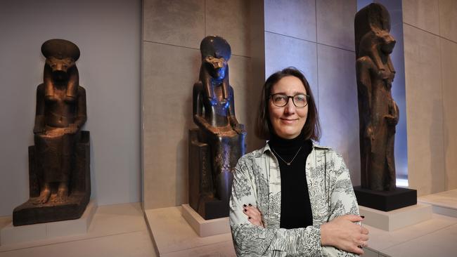 British Museum curator Marie Vandenbeusch with statues of the ancient Egyptian goddess Sekhmet, part of the National Gallery of Victoria exhibition running until October 6. It is the largest display of Egyptian antiquities seen in Australia. Picture: David Caird