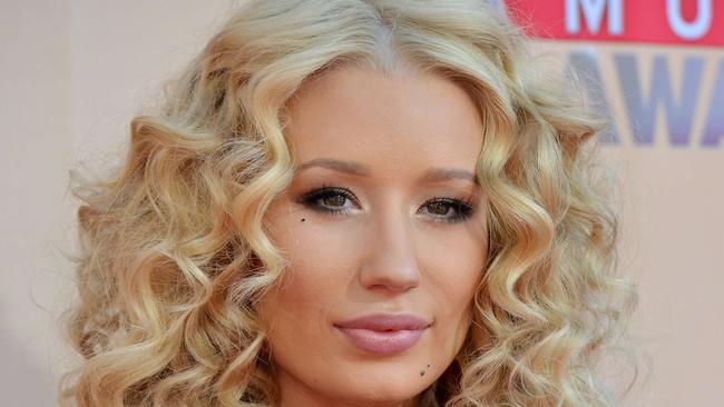 (FILES) - A file picture taken on March 29, 2015, rapper Iggy Azalea arrives on the red carpet for the iHeartRadio Music Awards held at the Shrine Auditorium in Los Angeles, California. Hip-hop star Iggy Azalea, whose meteoric career rise has brought both a wide fan base and intense criticism, has said in June 2015, she canceled her tour because she needed a "mental break." AFP PHOTO/ VALERIE MACON