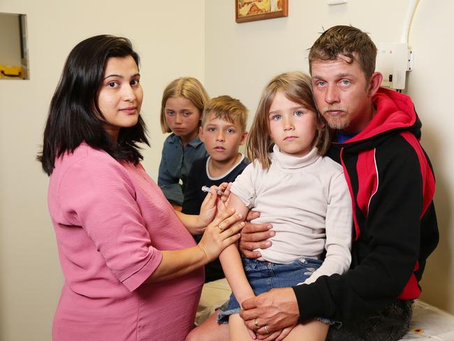 Daniel Foulds gets the flu shot with his children Lily, 11, Cory, 10, Indy, 7, and Dr Neupane at Toowoomba Medical Centre. Picture: AAP Image/Claudia Baxter