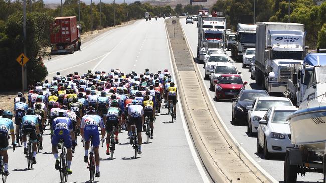 The peloton travels along the Port River Expressway during this year’s Tour Down Under. Picturre: Sarah Reed