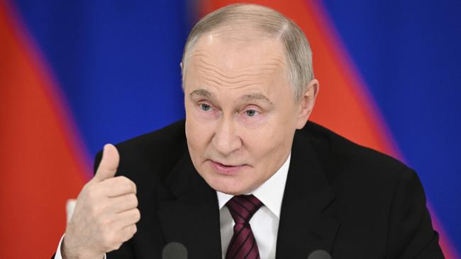 Vladimir Putin gestures as he speaks to journalists in the Grand Palace at the Kremlin in Moscow on Sunday. Picture: Sergei Bobylev/Photo host agency RIA Novosti/AP
