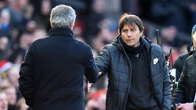 Manchester United's Portuguese manager Jose Mourinho (L) shakes hands with Chelsea's Italian head coach Antonio Conte