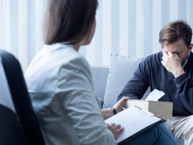 Photo of professional female counselor helping depressed man