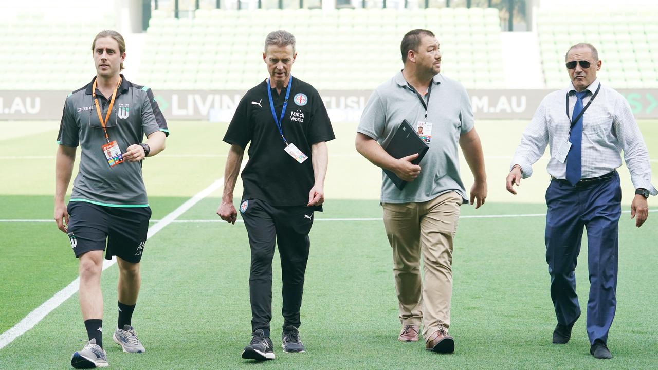 Club officials from Western United and Melbourne City discuss the air quality prior to the game at AAMI Park.