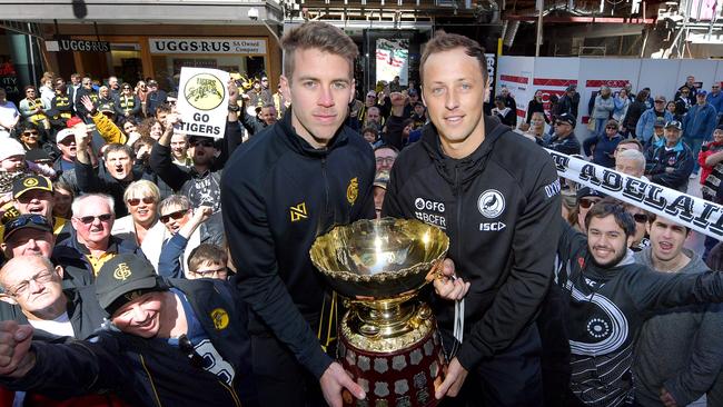 Glenelg Captain Chris Curran holds the Premiership Cup with Port Adelaide captain Cameron Sutcliffe during the Rundle Mall Grand Final Eve Presentations. Picture: AAP Image/Mark Brake