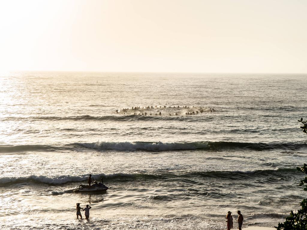 Surfers making there way out to sea to pay tribute to Annalise Braakensiek at the Memorial held at Bondi Beach around 7am Wednesday January 16 Image Picture: Monique Harmer