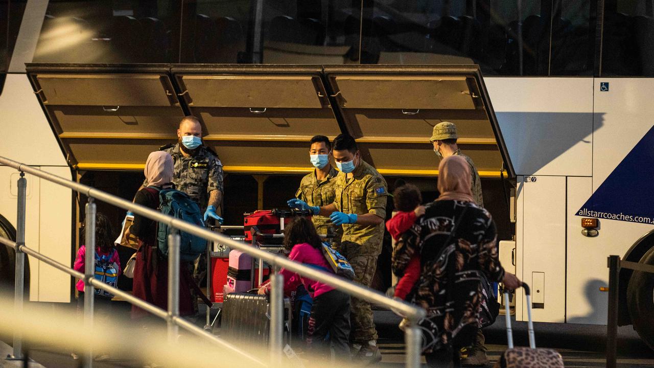 Airline crew and passengers at Sydney International Airport before being transferred to hotel quarantine in Sydney. Picture: NCA NewsWire / Flavio Brancaleone