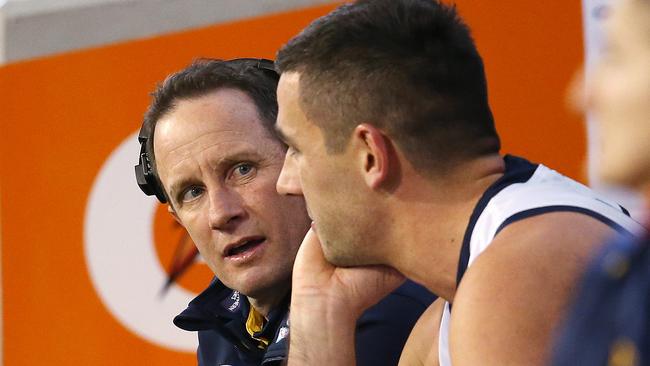 Adelaide coach Don Pyke talks with skipper Taylor Walker on the bench during the Crows’ disastrous third quarter against Hawthorn. Picture: Michael Klein