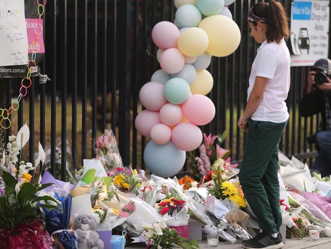 A girls takes in the memorial site. Picture: John Grainger