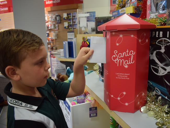 Blake Thomsen sending his Santa letter in Gladstone's Australia Post Office, November 18.