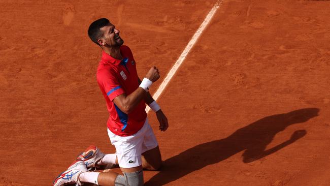 PNovak Djokovic dropped to his knees after the winning point. Picture: Getty Images