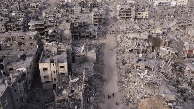 Palestinians walk through the destruction caused by the Israeli air and ground offensive in Rafah, Gaza Strip, on January 21. Picture: AP Photo