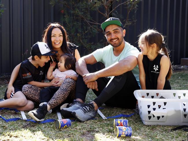 Daniel Ucchino doing a home workout with his wife Mika, and kids Zen, Lotus and Bodhi.