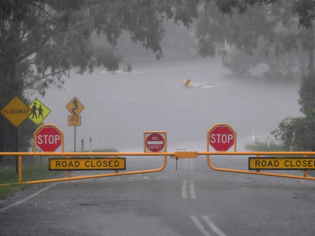 Torrential rain and major flooding around Brisbane and a road closed at Young's crossing road in Bray Park. Picture: NCA NewsWire / John Gass