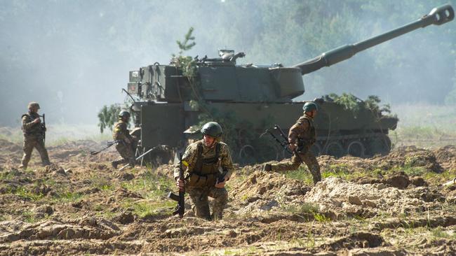 Troops near self-propelled howitzers in an undisclosed location in Ukraine. Picture: AFP