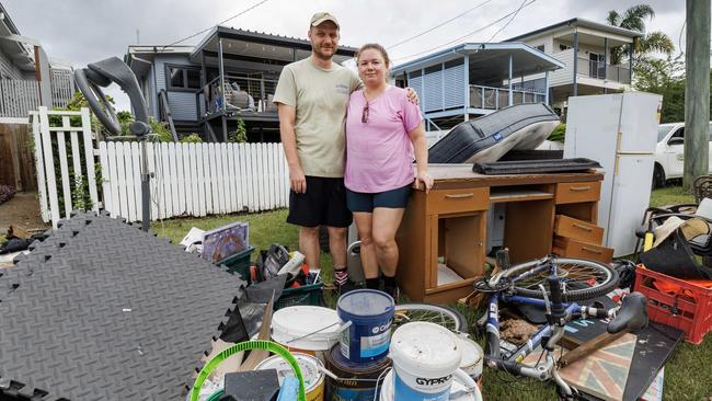 Carina couple Alex and Katie Abson among their flood-damaged possessions. Picture Lachie Millard
