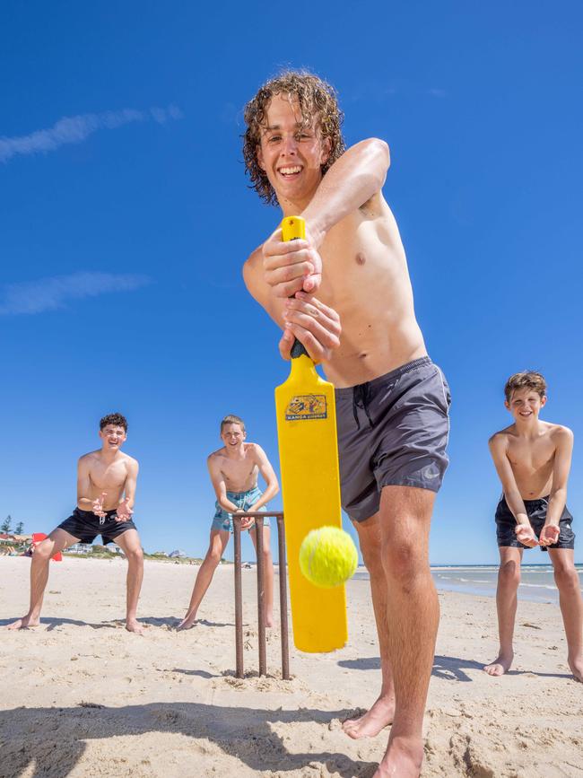 Owen Lowe playing beach cricket with Mason Dixon, Austin Lowe, and Lewis Lowe. Picture: Ben Clark/NCA Newswire