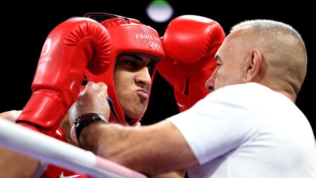 Team Algeria coach Mohamed Al-Shawa assists Imane Khelif ahead of the fight. (Photo by Richard Pelham/Getty Images)