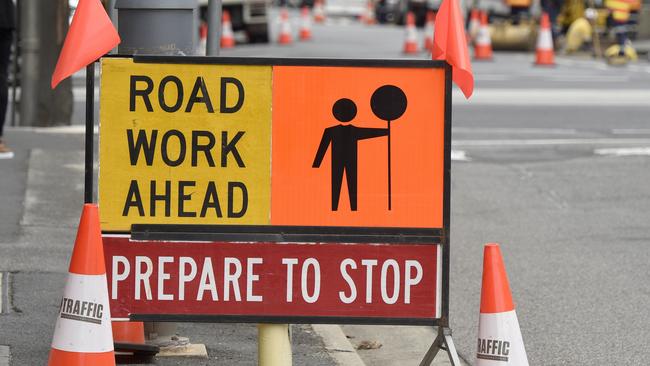 MELBOURNE, AUSTRALIA - NewsWire Photos FEBRUARY 15, 2022: Generic stock images of construction crews. Workers at a sewage infrastructure in inner Melbourne with a Road Work Ahead sign in the foreground. Picture: NCA NewsWire / Andrew Henshaw