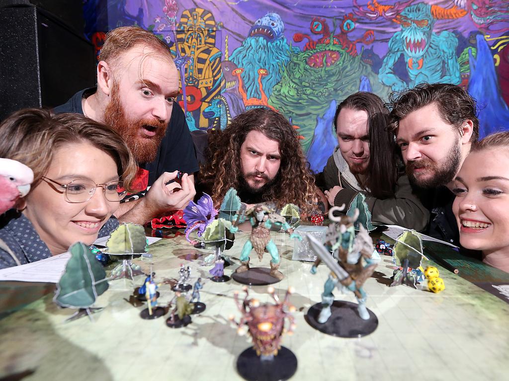 Morgan Bidlake (with Thomathan the bird), Sean Deane, Mitch Wilkins, Tim Sifontes-Holzberger, Tyson Hargreaves, Jade Murray engage in a round of Dungeons and Dragons at Netherworld, an arcade/pub in Brisbane's Fortitude Valley. Picture: Richard Gosling