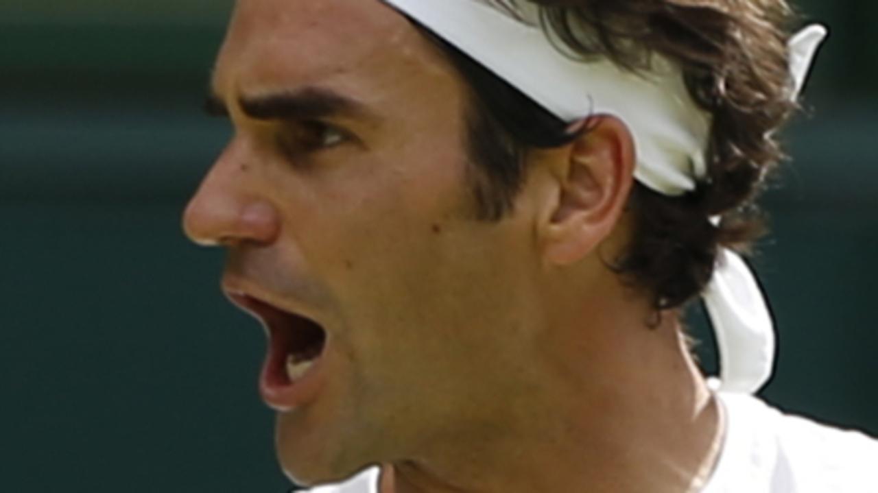 Roger Federer of Switzerland celebrates winning a point against point Sam Querrey of the United States, during their singles match at the All England Lawn Tennis Championships in Wimbledon, London, Thursday July 2, 2015. (AP Photo/Pavel Golovkin)