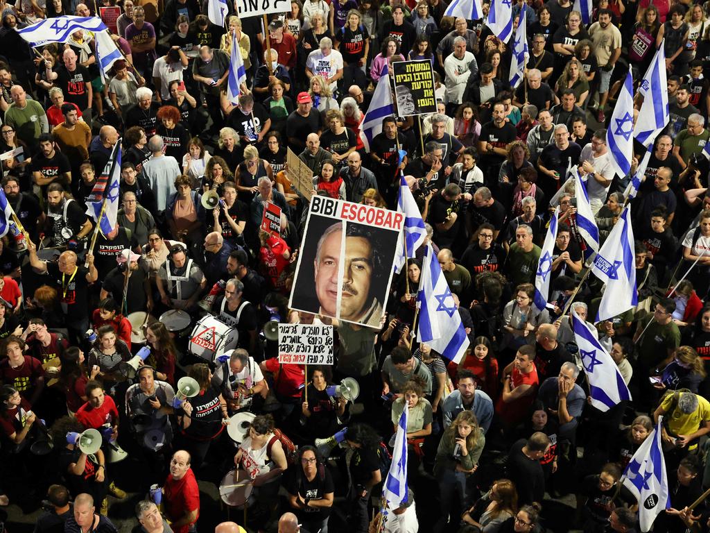 Relatives and supporters of Israeli hostages, taken during the October 7 attacks by Hamas militants, rally with placards and Israeli flags outside the Defense Ministry in Tel Aviv. Picture: Jack Guez/AFP