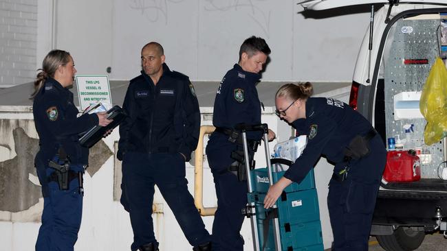 Police preparing to enter the apartment where the two sisters’ bodies were found. Picture: Damian Shaw / Daily Telegraph