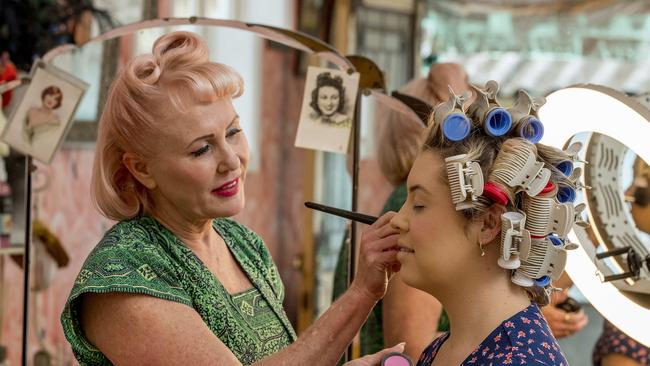 Miss Chrissy applying makeup after putting in hotrollers. Picture: Jerad Williams