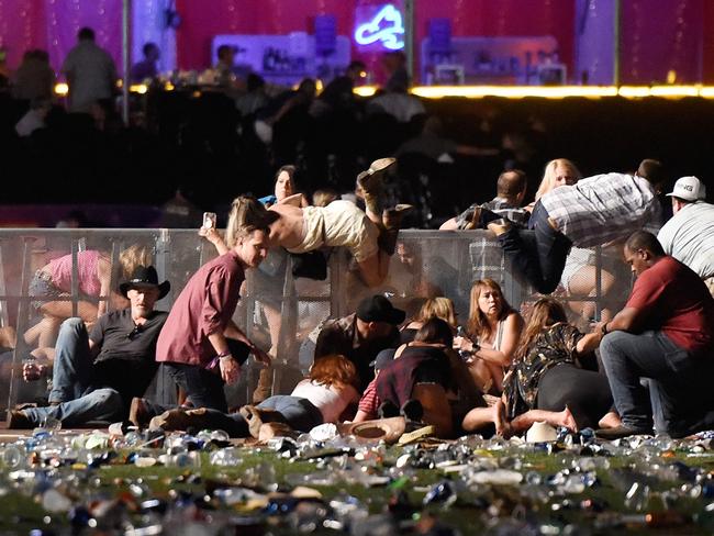 People scramble for shelter at the Route 91 Harvest country music festival after gun fire was heard in October 2017 in Las Vegas, Nevada. Photo: David Becker