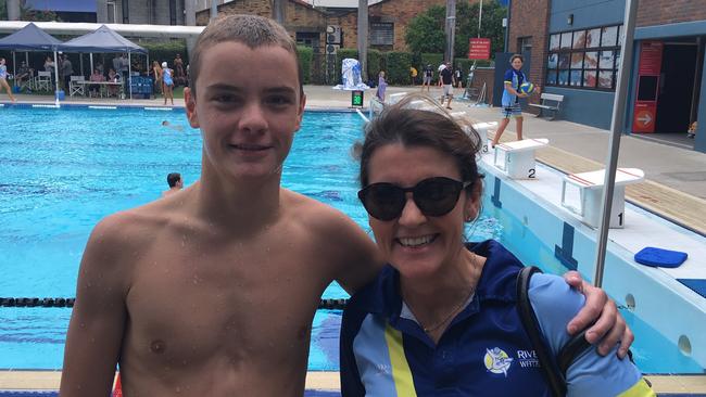 Son and mother, player and manager, Sam Powell, left, with Rachel Thomson from the winning under 15As River City side.. 